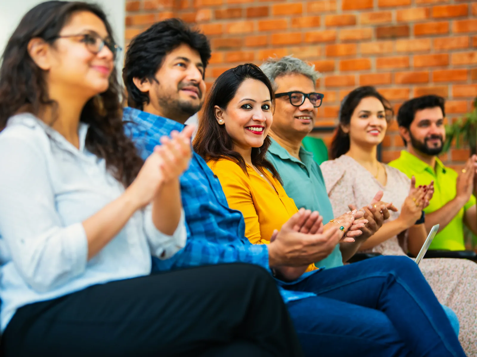A group of contemporary Indian adults in a warm group conversation